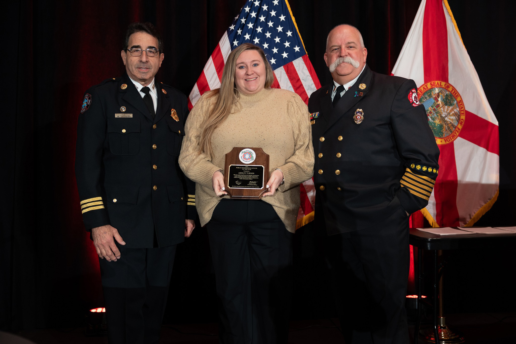 Item 3 of 12 in gallery section. Title is Ashley Turner receiving PIO of the Year.
