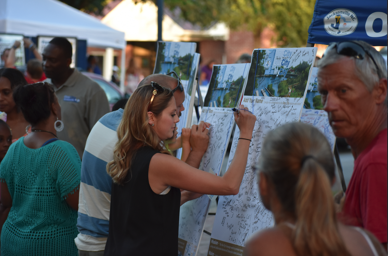 Image 4 of 9 in gallery section. Image title is Citizens Sign the One City Pledge.