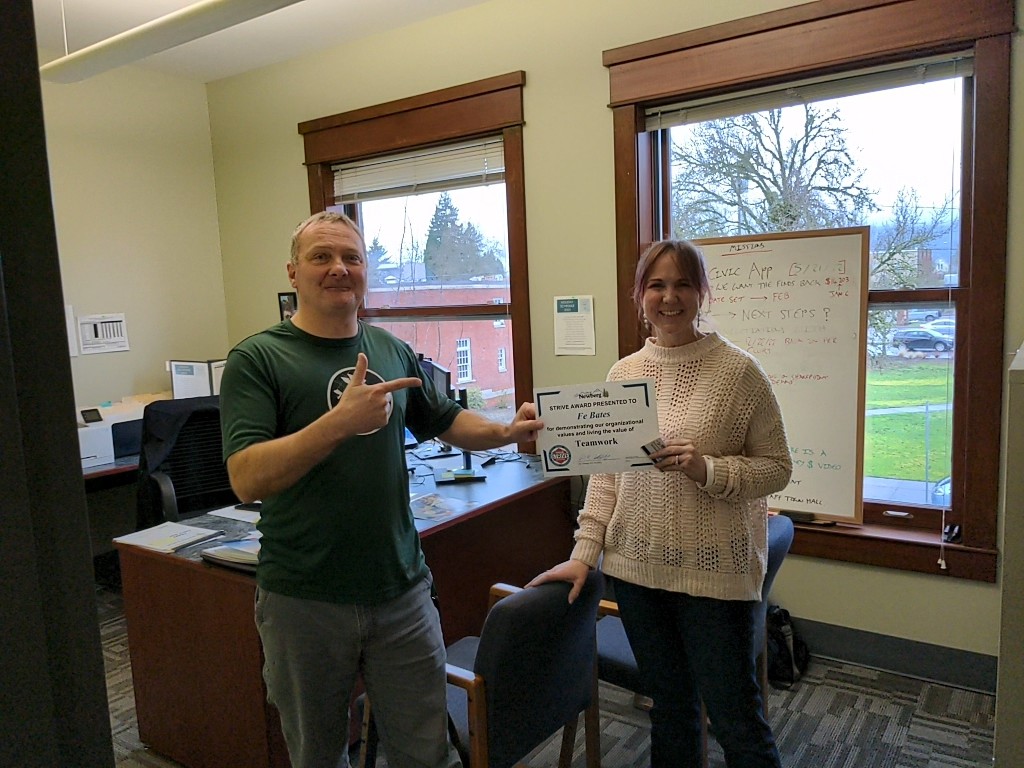 Image 1 of 5 in gallery section. Image title is Fe is presented with the award for Teamwork..