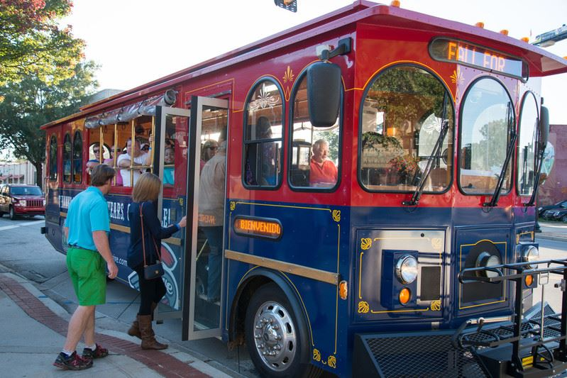 Photo of people boarding trolley