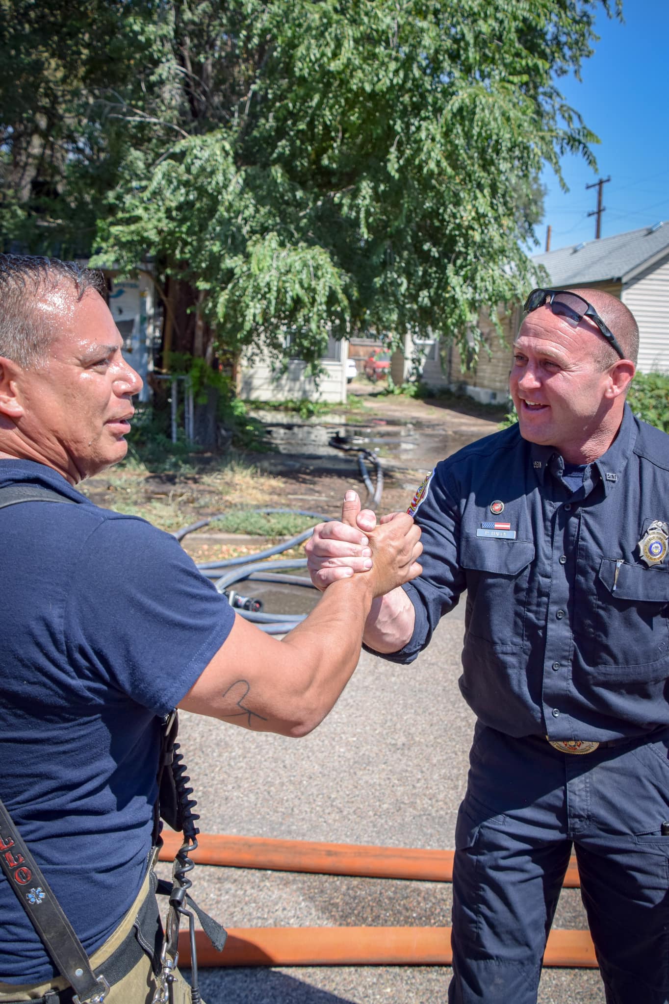 Image 4 of 14 in gallery section. Image title is Firefighters shaking hands.