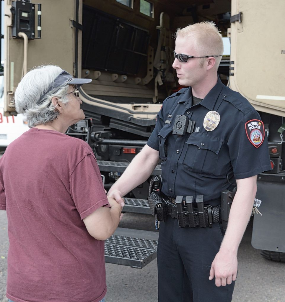Image 6 of 14 in gallery section. Image title is Police Officer greeting citizen.