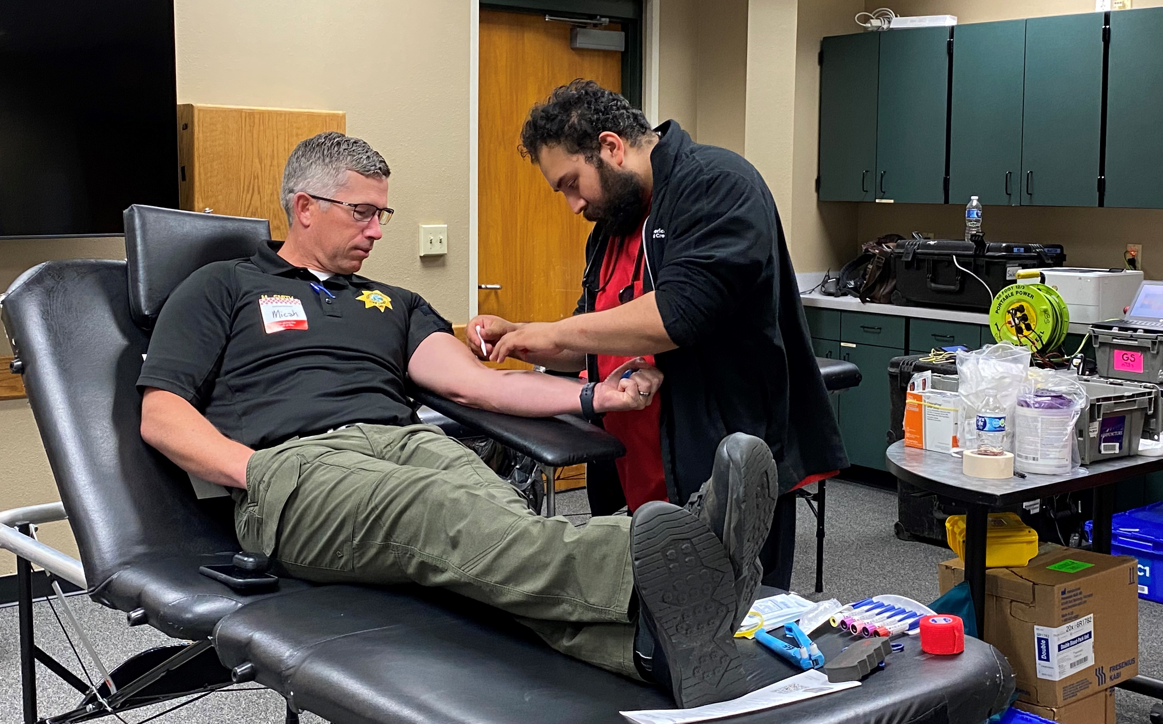 Image 15 of 18 in gallery section. Image title is Smith giving blood.