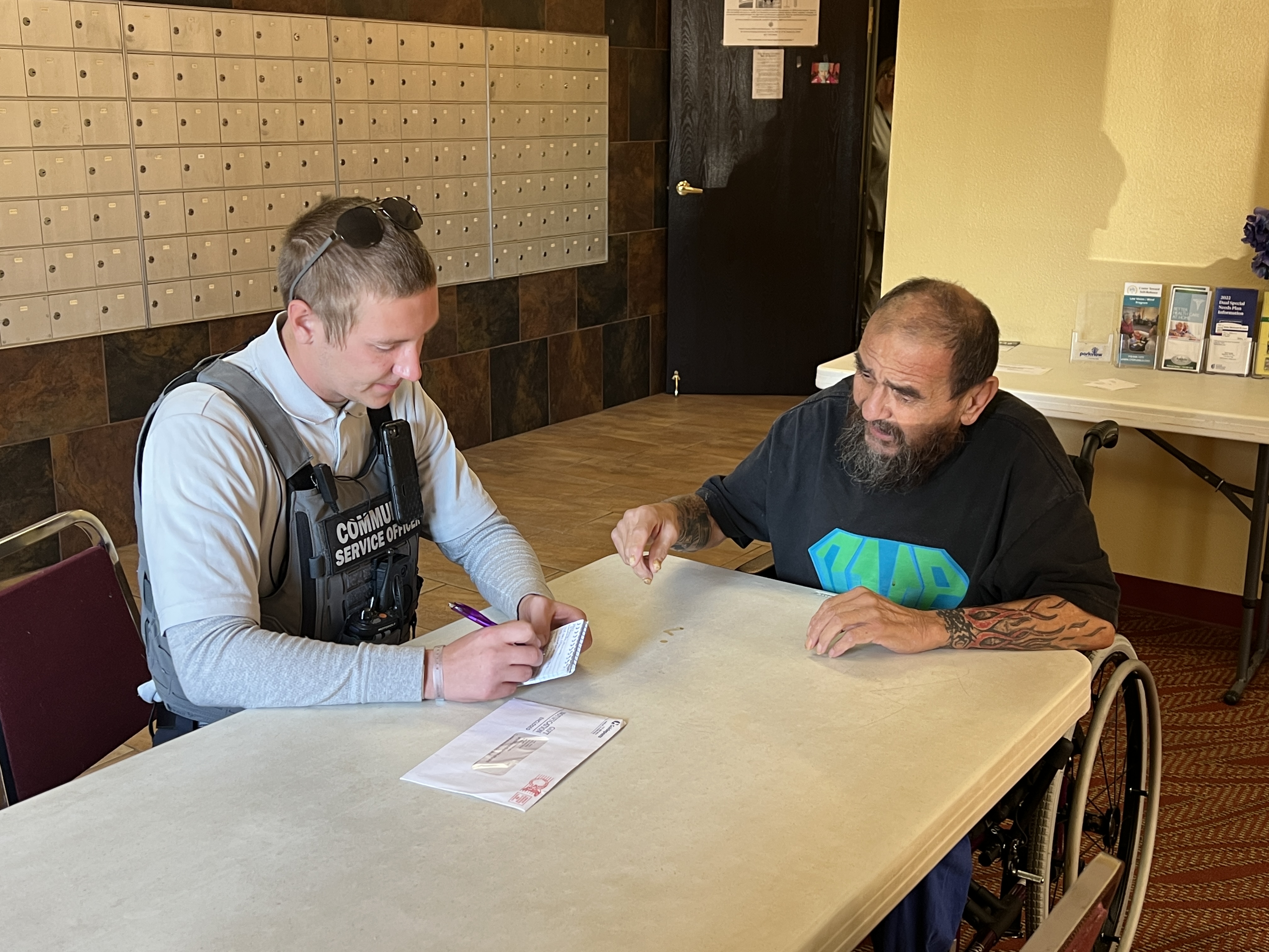 Image 7 of 14 in gallery section. Image title is Community Service Officer working with a citizen.